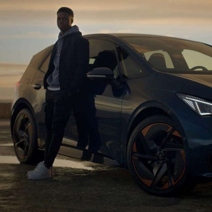 Ansu Fati laying on a CUPRA Born with Blizzard wheels