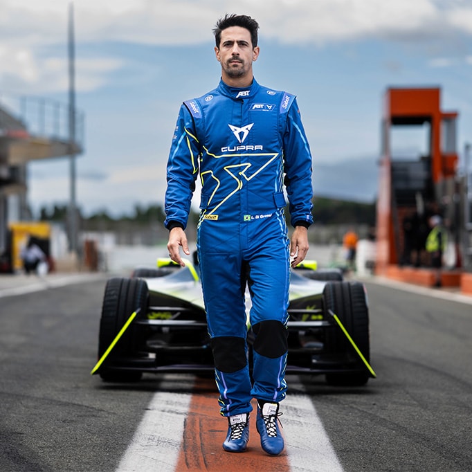  lucas di grassi standing in front of cupra electric race car