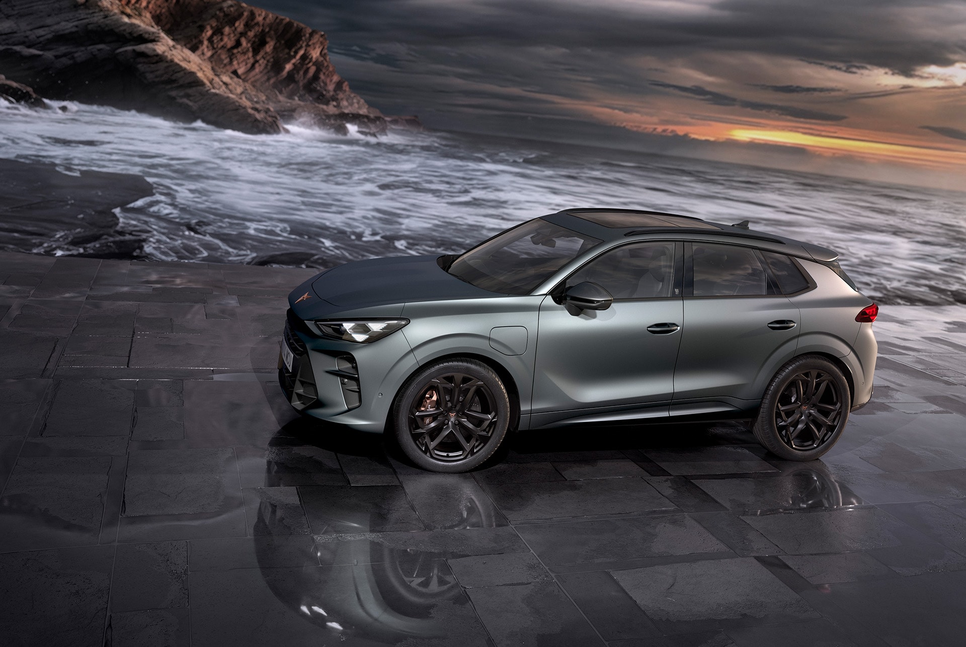 cupra terramar hybrid suv, new 2024 model, side view, featuring 20-inch america’s cup alloy wheels and akebono brakes, enceladus grey matt, on a wet pavement by the sea at sunset. 