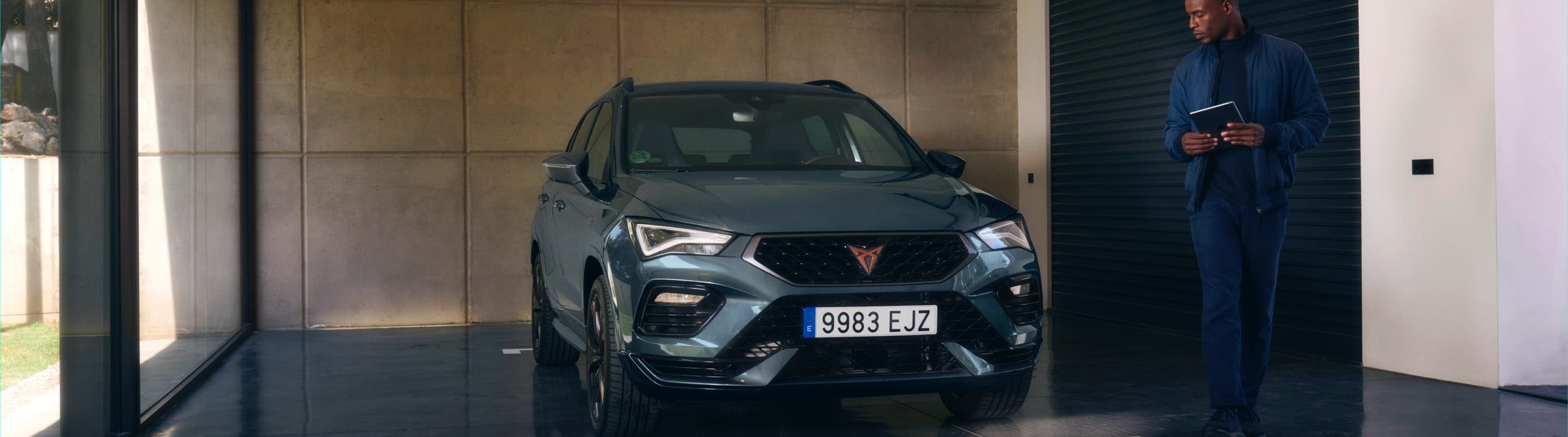 woman-walking-in-front-of-cupra-ateca-graphite-grey